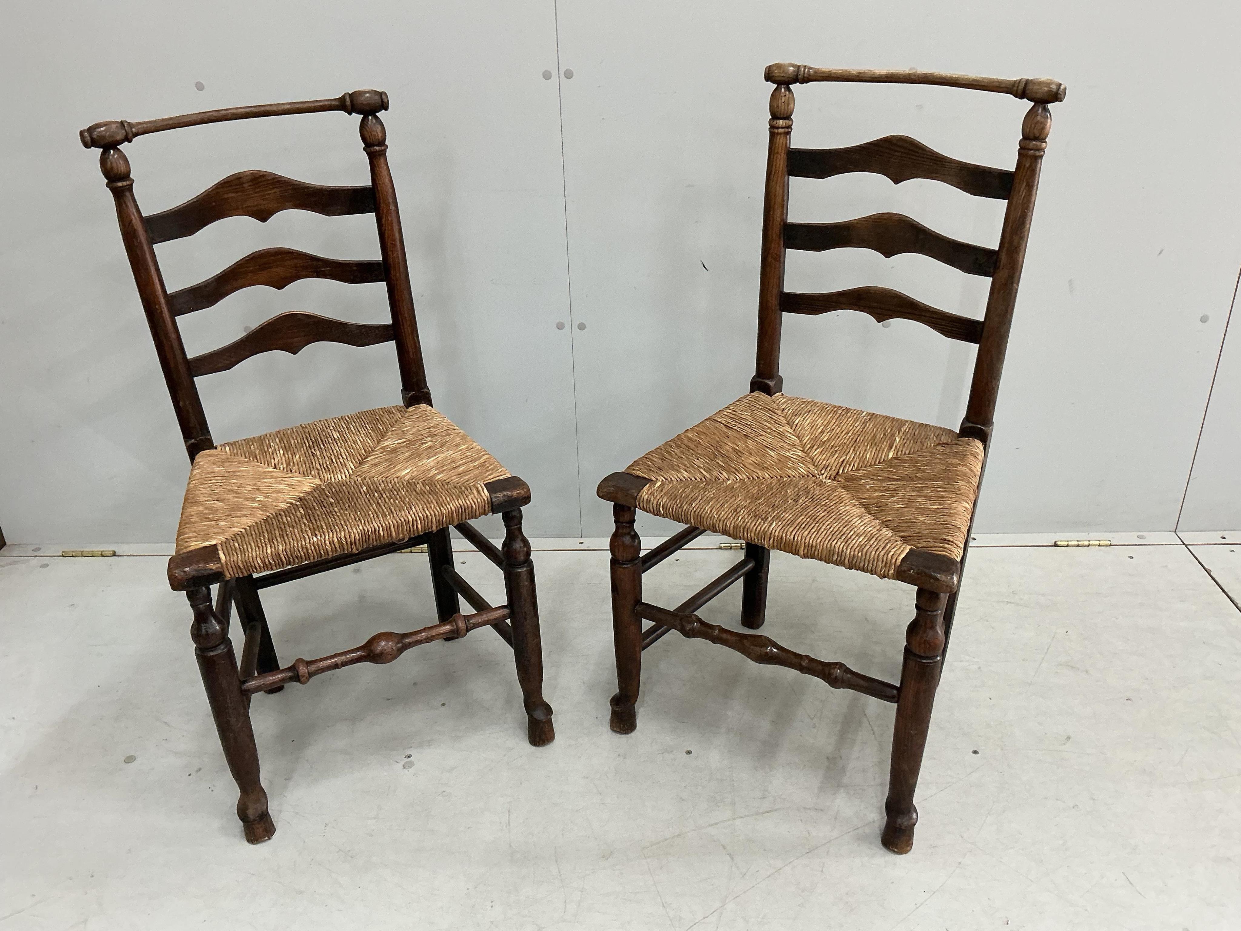 A harlequin set of eight 18th century ash ladderback rush seat dining chairs, two with arms